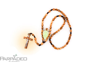 Religious inspired beaded olive wood car decoration features a hand blown glass amulet filled with Holy Water from the Jordan River. Handmade by PARPADEO - Israel.